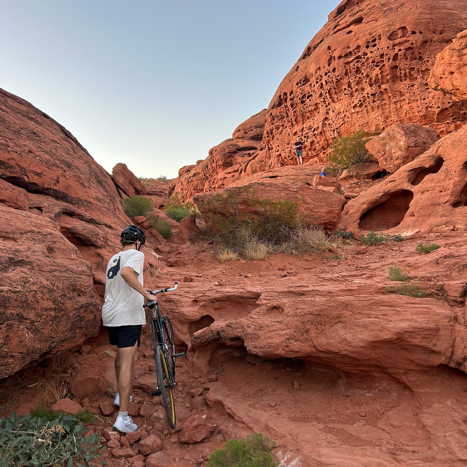 Walking bike up rocks in pioneer park near st george utah