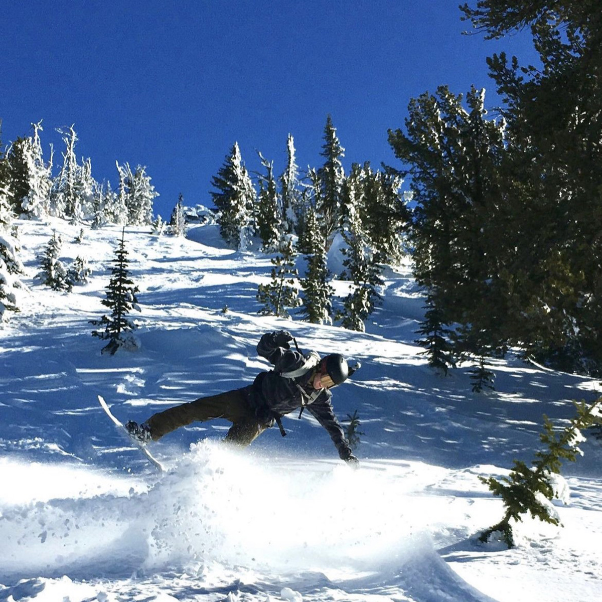 Snowboarder crashing in the backcountry with anon snowboard goggles