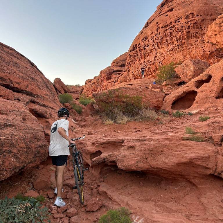 Walking a bike through the red rock formations of Pioneer Park, St. George