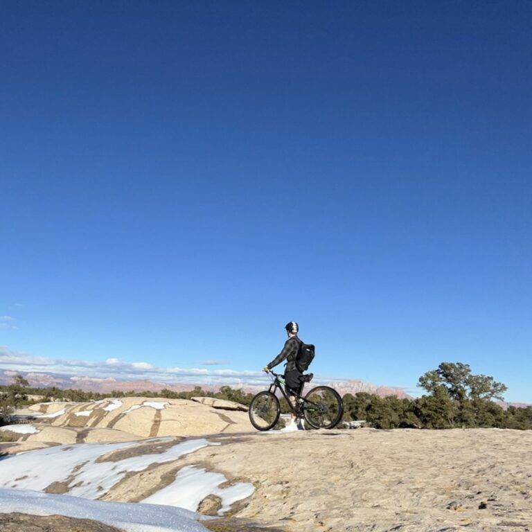 Cyclist overlooking red rock canyon country from Gooseberry Mesa